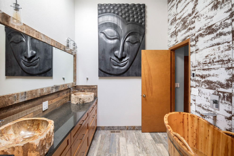 Bathroom - mid-sized tropical master multicolored tile and metal tile light wood floor and gray floor bathroom idea in Portland with shaker cabinets, dark wood cabinets, white walls, a vessel sink, quartz countertops, a hinged shower door and black countertops