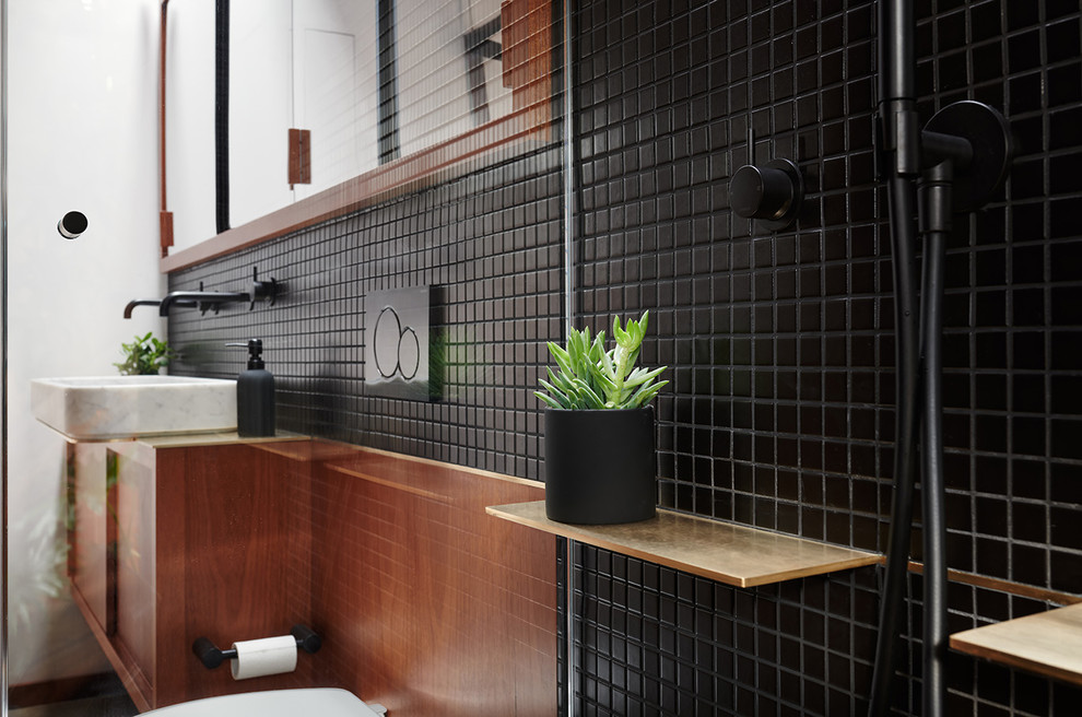 Bathroom - small modern master black tile and ceramic tile concrete floor and gray floor bathroom idea in San Francisco with flat-panel cabinets, medium tone wood cabinets, a wall-mount toilet, black walls and a pedestal sink