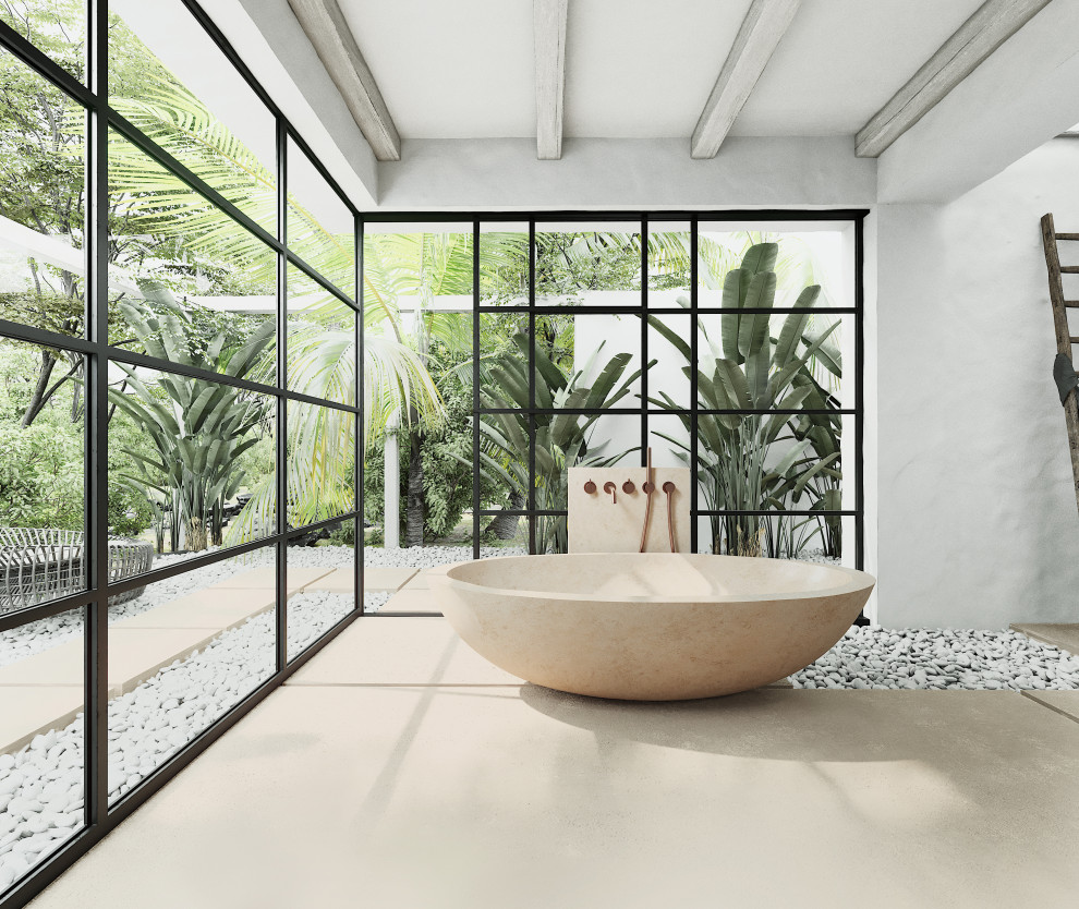 Ispirazione per una stanza da bagno tropicale con vasca freestanding, pavimento in marmo e pavimento beige