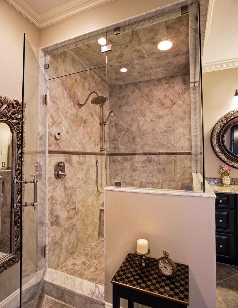 Corner shower - mid-sized traditional master gray tile and porcelain tile porcelain tile corner shower idea in Charlotte with an undermount sink, raised-panel cabinets, black cabinets, granite countertops, a two-piece toilet and beige walls