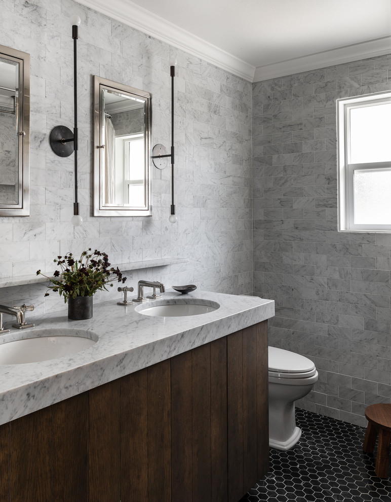 This is an example of a classic bathroom in Seattle with flat-panel cabinets, dark wood cabinets, a submerged sink, black floors and white worktops.