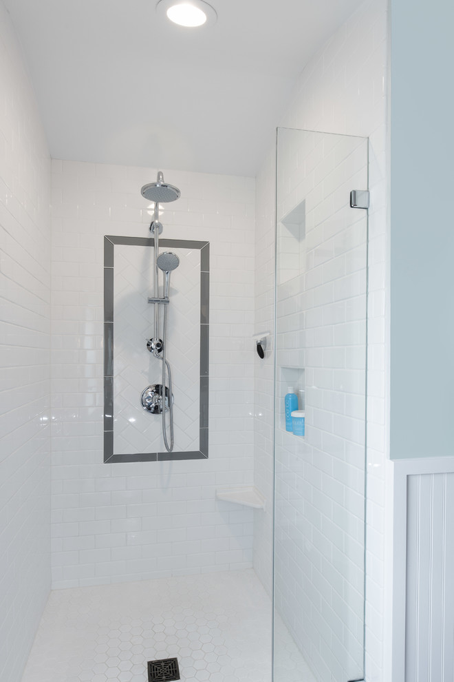 Alcove shower - small traditional master white tile and porcelain tile porcelain tile alcove shower idea in Seattle with an undermount sink, shaker cabinets, white cabinets, quartz countertops, a two-piece toilet and blue walls