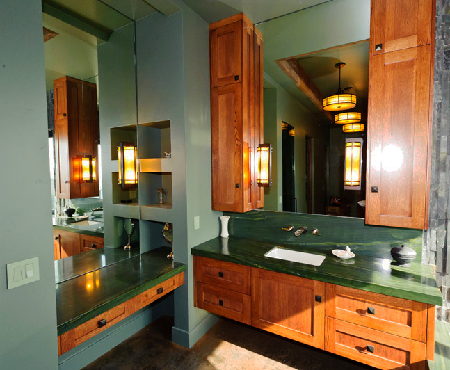 This is an example of a medium sized classic family bathroom in Sacramento with a submerged sink, shaker cabinets, medium wood cabinets, granite worktops, a submerged bath, green walls and concrete flooring.