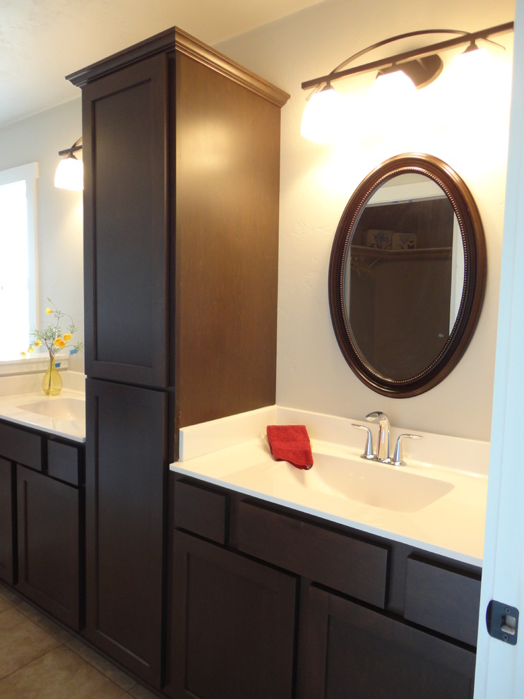 This is an example of a medium sized traditional ensuite bathroom in Milwaukee with an integrated sink, recessed-panel cabinets, dark wood cabinets, a walk-in shower, a two-piece toilet, ceramic tiles, beige walls and ceramic flooring.