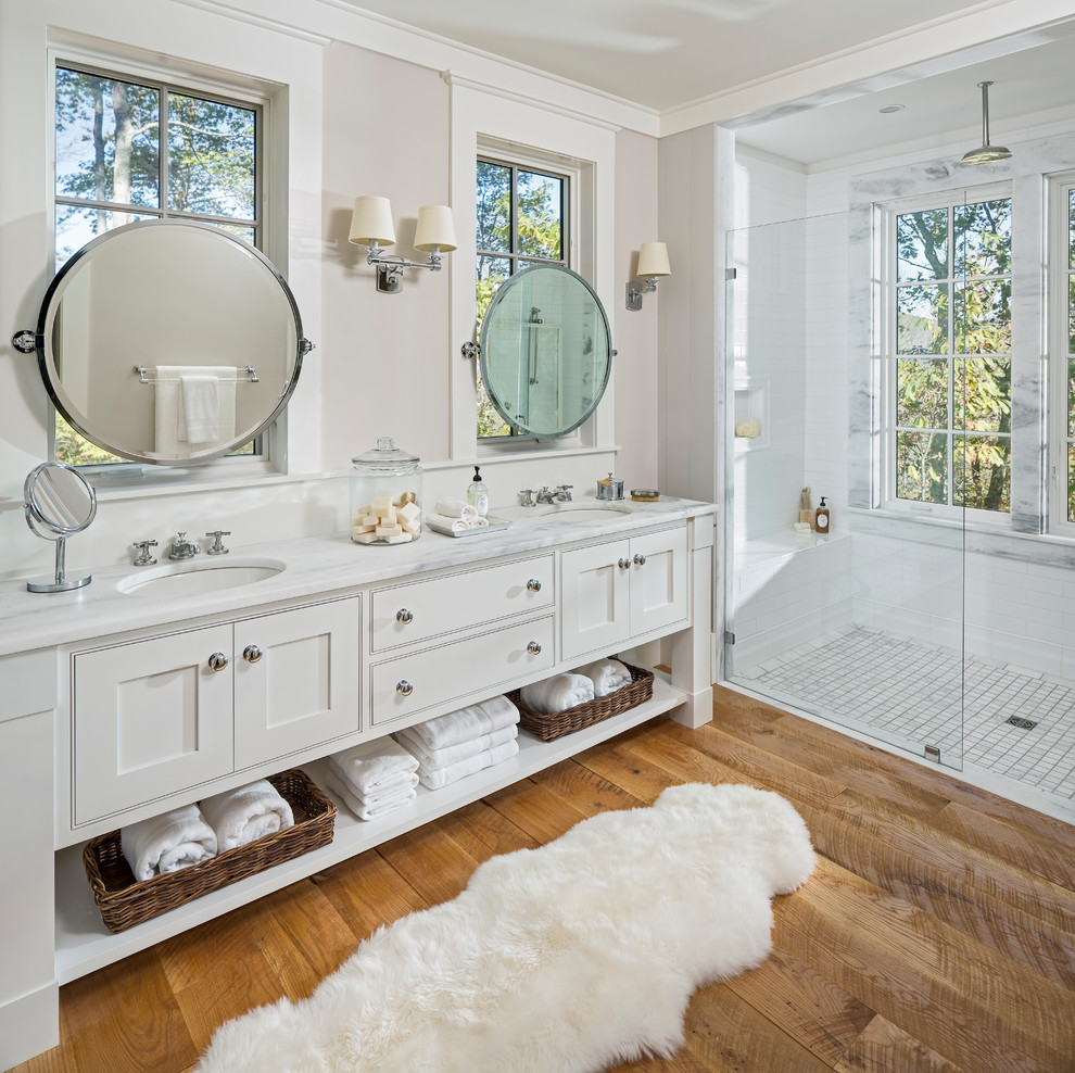 This is an example of a rustic ensuite bathroom in Other with beaded cabinets, white cabinets, a built-in shower, white tiles, beige walls, medium hardwood flooring, a submerged sink and white worktops.