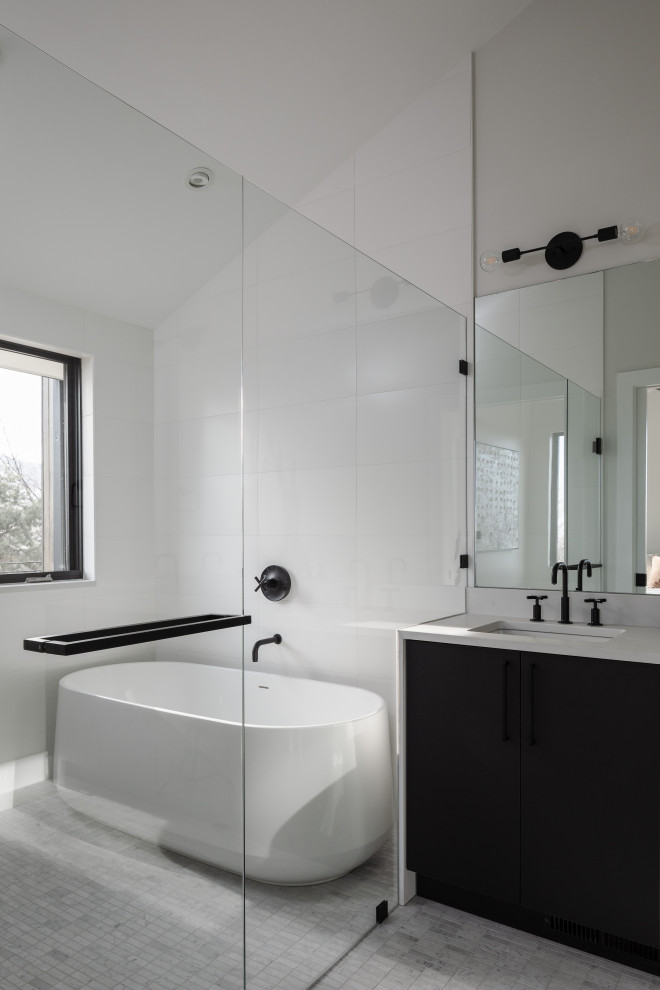Inspiration for a large contemporary master white tile gray floor bathroom remodel in Denver with flat-panel cabinets, black cabinets, gray walls, an undermount sink, a hinged shower door and white countertops