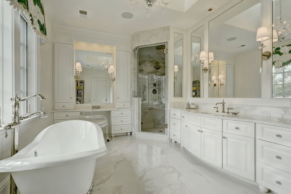 Photo of a large traditional ensuite bathroom in Baltimore with white cabinets, a claw-foot bath, an alcove shower, a one-piece toilet, white tiles, white walls, white floors and a hinged door.