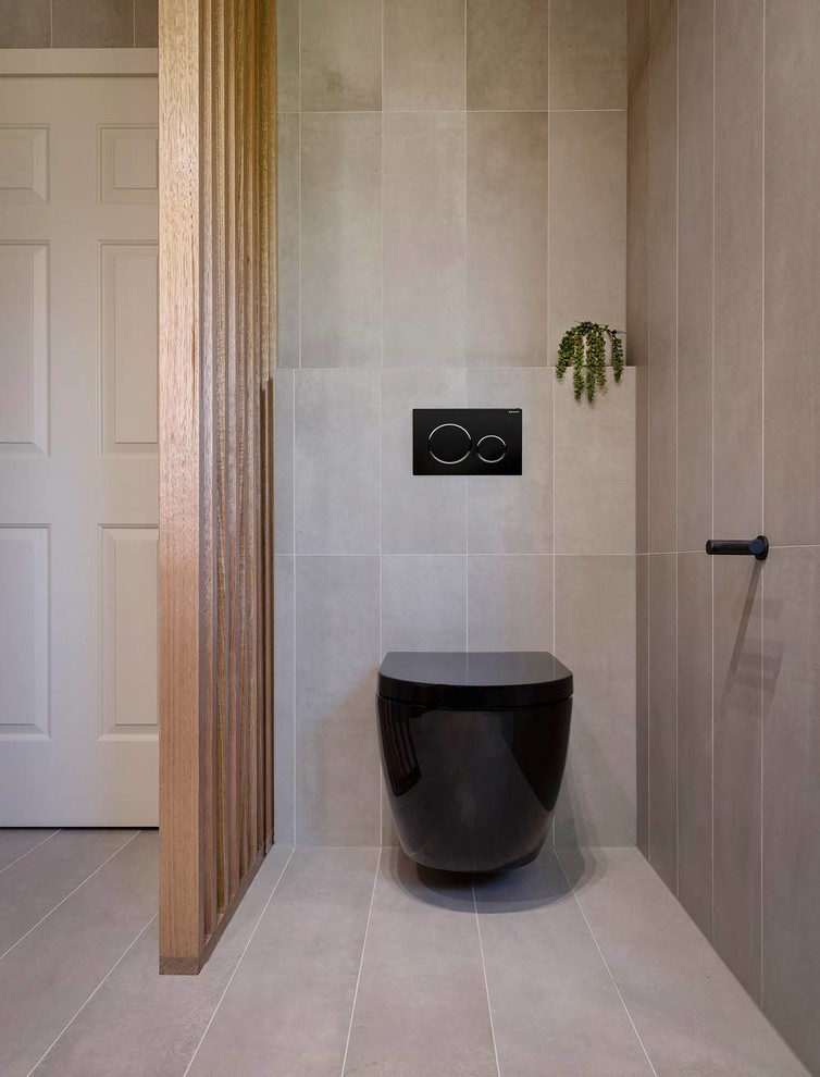 Inspiration for a mid-sized contemporary 3/4 gray tile and porcelain tile porcelain tile and gray floor walk-in shower remodel in Melbourne with flat-panel cabinets, black cabinets, a wall-mount toilet, gray walls, a vessel sink, wood countertops and brown countertops
