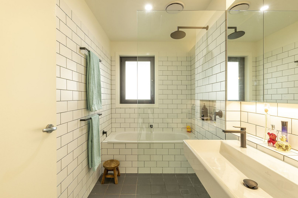 Inspiration for a small contemporary ensuite wet room bathroom in Canberra - Queanbeyan with white cabinets, a built-in bath, a one-piece toilet, white tiles, ceramic tiles, white walls, ceramic flooring, a wall-mounted sink and an open shower.