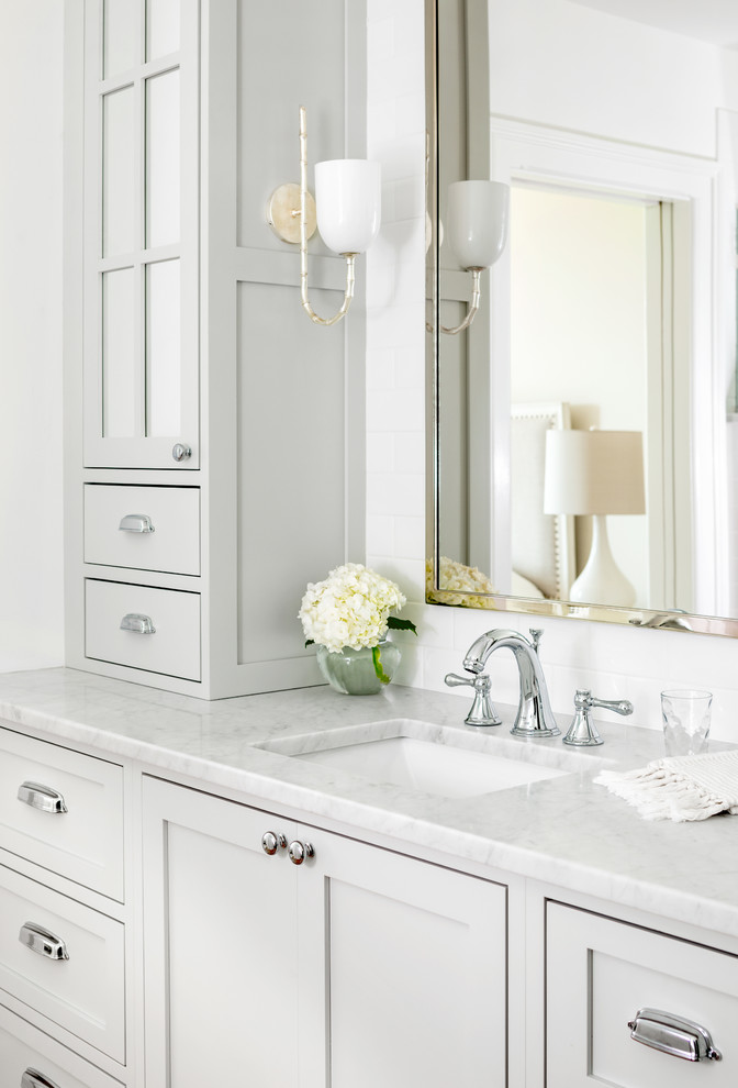 Mid-sized elegant master white tile and subway tile bathroom photo in Bridgeport with recessed-panel cabinets, gray cabinets, a one-piece toilet, white walls, an undermount sink, marble countertops and white countertops
