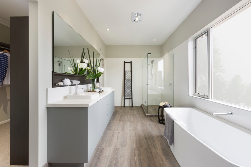Large traditional ensuite bathroom in Melbourne with marble worktops, a freestanding bath, a corner shower, white tiles and ceramic tiles.