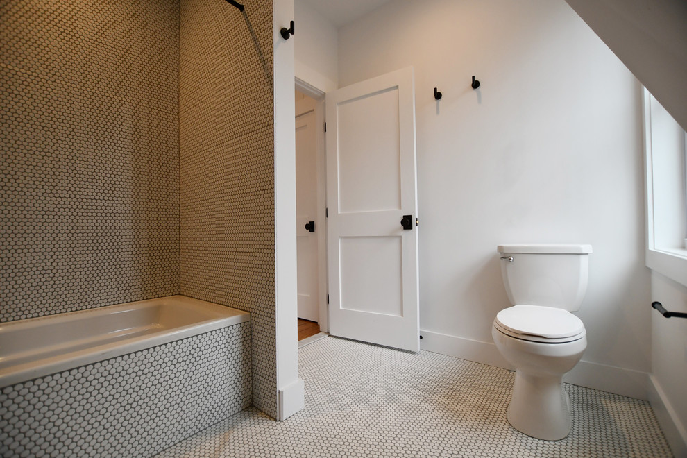 This is an example of a medium sized farmhouse bathroom in New York with an alcove shower, a two-piece toilet, white tiles, ceramic tiles, white walls, medium hardwood flooring, a wall-mounted sink, brown floors and a hinged door.