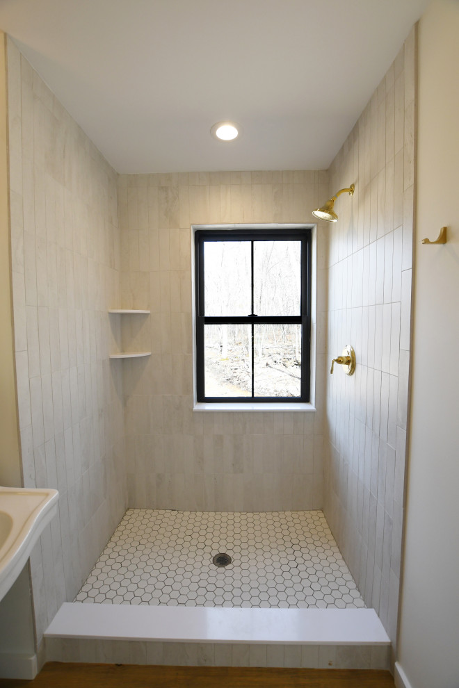 Inspiration for a medium sized rural bathroom in New York with white cabinets, an alcove shower, grey tiles, ceramic tiles, green walls, medium hardwood flooring, a pedestal sink, brown floors, an open shower, a single sink, a freestanding vanity unit and panelled walls.
