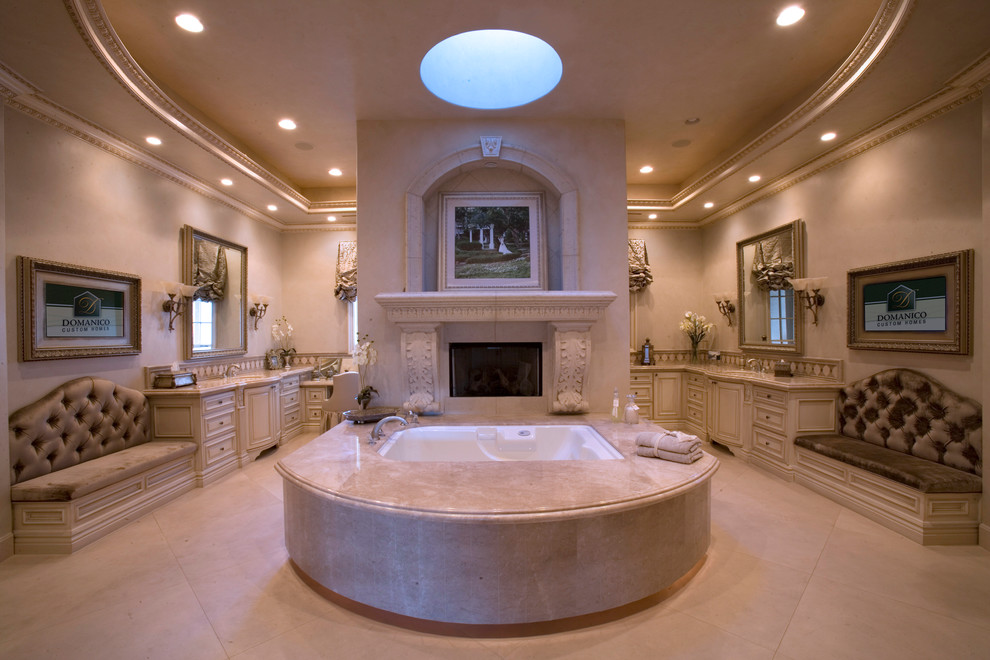 Example of a large tuscan master beige floor bathroom design in Las Vegas with raised-panel cabinets, white cabinets, a hot tub, brown walls and an undermount sink