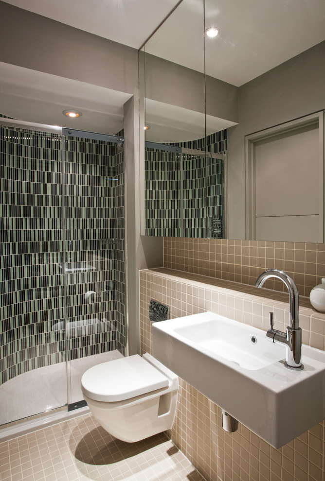 Photo of a small contemporary bathroom in London with a wall mounted toilet, an alcove shower, a wall-mounted sink and grey walls.