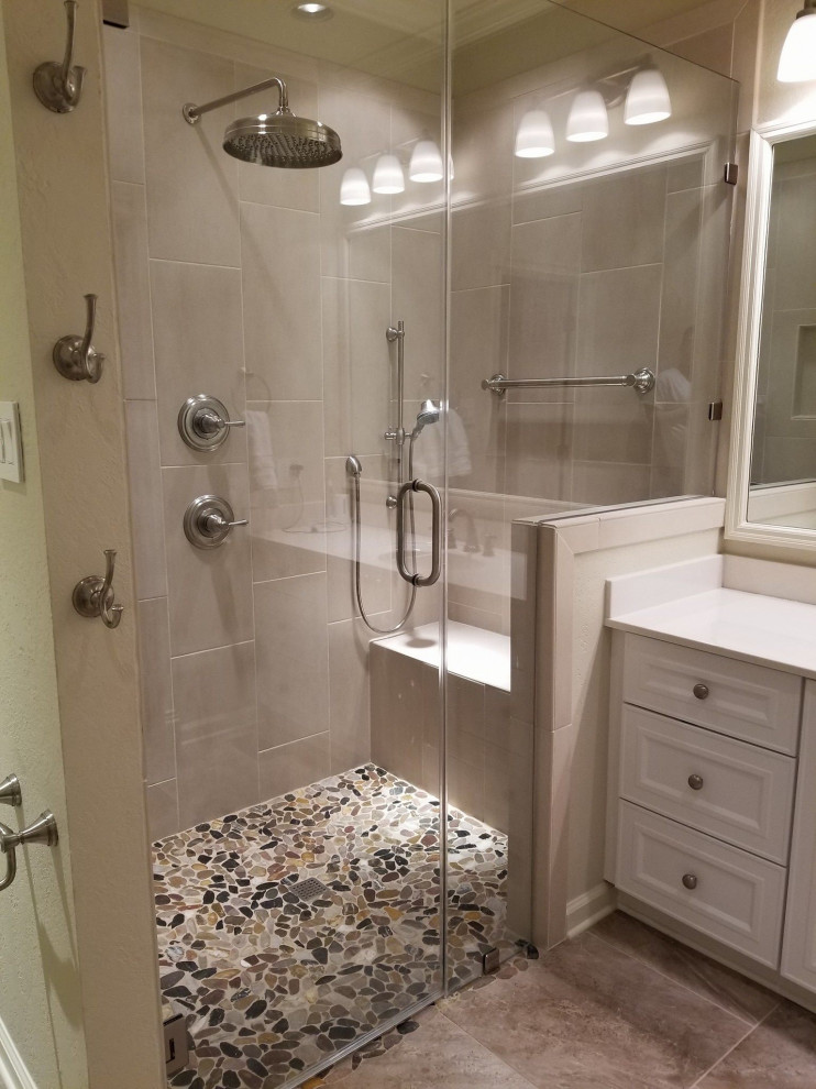 Example of a master pebble tile floor bathroom design in Little Rock with a hinged shower door