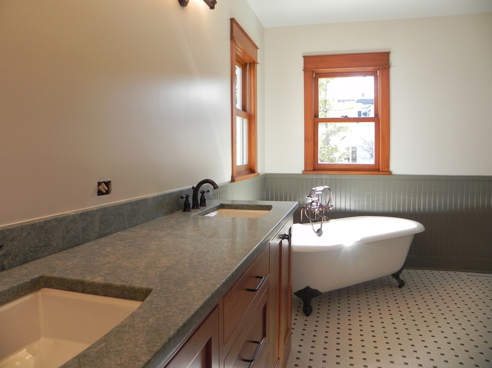 Large farmhouse ensuite bathroom in Chicago with a submerged sink, flat-panel cabinets, medium wood cabinets, granite worktops, a claw-foot bath, a corner shower, a two-piece toilet, black and white tiles, ceramic tiles, grey walls and ceramic flooring.