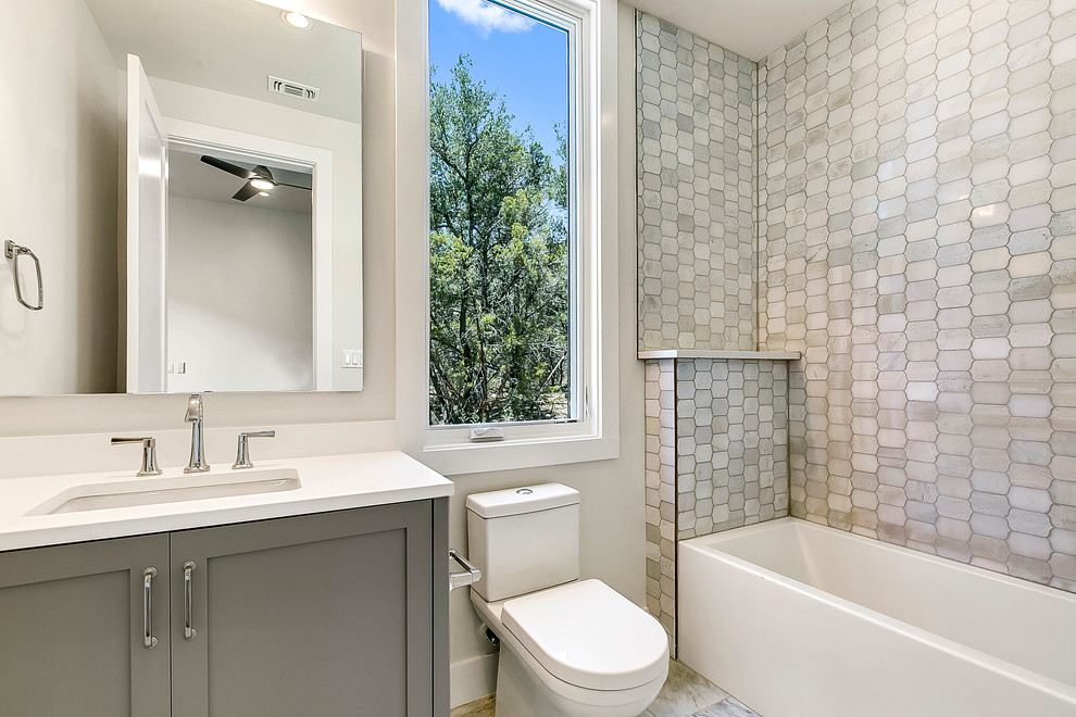 Inspiration for a large contemporary bathroom in Austin with shaker cabinets, grey cabinets, an alcove bath, an alcove shower, grey tiles, marble tiles, white walls, marble flooring, a submerged sink, marble worktops, grey floors and white worktops.