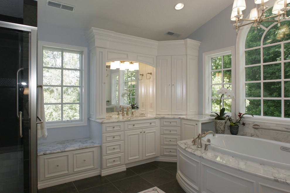 Example of a mid-sized classic master ceramic tile bathroom design in Salt Lake City with raised-panel cabinets, white cabinets, blue walls, an undermount sink and marble countertops