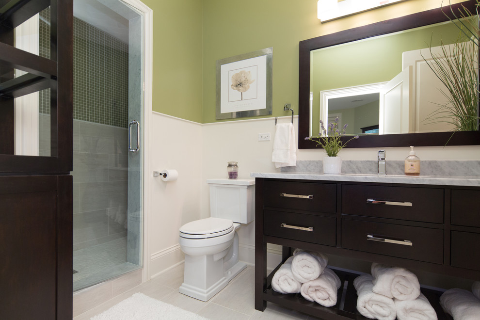 Mid-sized transitional beige tile and porcelain tile porcelain tile alcove shower photo in Chicago with an undermount sink, furniture-like cabinets, dark wood cabinets, marble countertops and green walls