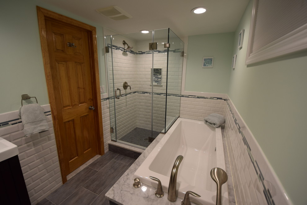 Design ideas for a medium sized classic bathroom in New York with a trough sink, recessed-panel cabinets, dark wood cabinets, a built-in bath, a corner shower, a two-piece toilet, white tiles, ceramic tiles, green walls, ceramic flooring and grey floors.