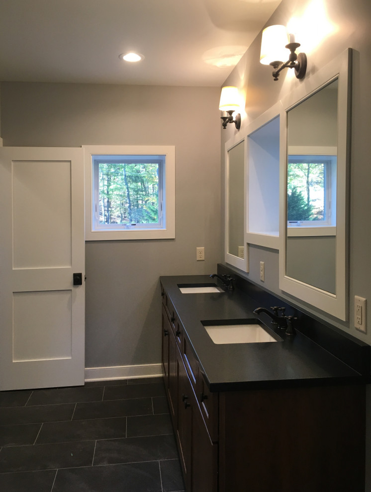 Medium sized traditional bathroom in Philadelphia with recessed-panel cabinets, white cabinets, a submerged bath, grey walls, ceramic flooring, a submerged sink, granite worktops, black floors, black worktops, double sinks and a built in vanity unit.