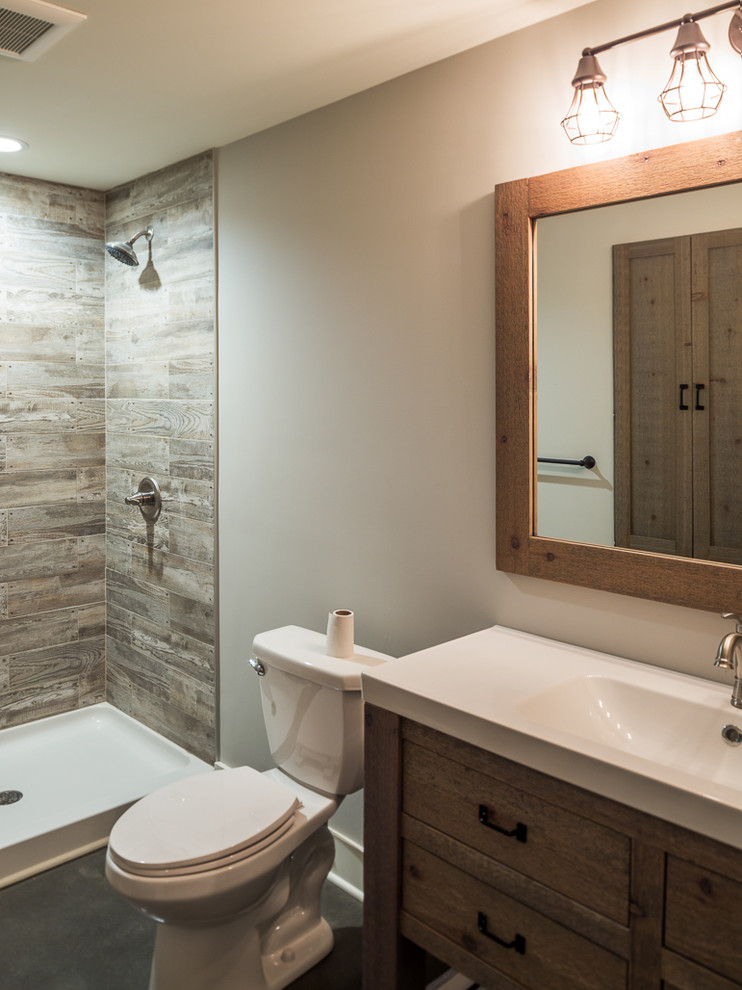 Inspiration for a mid-sized farmhouse 3/4 ceramic tile concrete floor and gray floor bathroom remodel in Minneapolis with open cabinets, distressed cabinets, a two-piece toilet, gray walls and an integrated sink