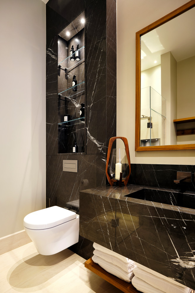 Photo of a medium sized contemporary shower room bathroom in London with a walk-in shower, a wall mounted toilet, limestone flooring, a built-in sink, marble worktops, a hinged door, grey worktops, a single sink and a built in vanity unit.