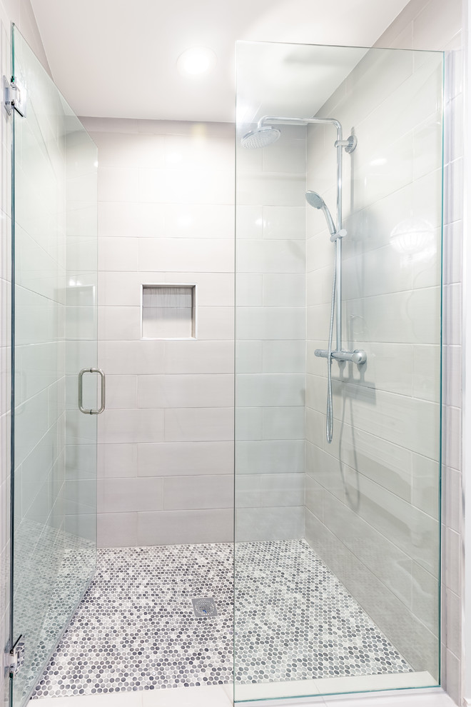 Design ideas for a medium sized modern shower room bathroom in Chicago with freestanding cabinets, white cabinets, a built-in shower, a one-piece toilet, white tiles, ceramic tiles, multi-coloured walls, ceramic flooring, a built-in sink, multi-coloured floors, a hinged door and multi-coloured worktops.