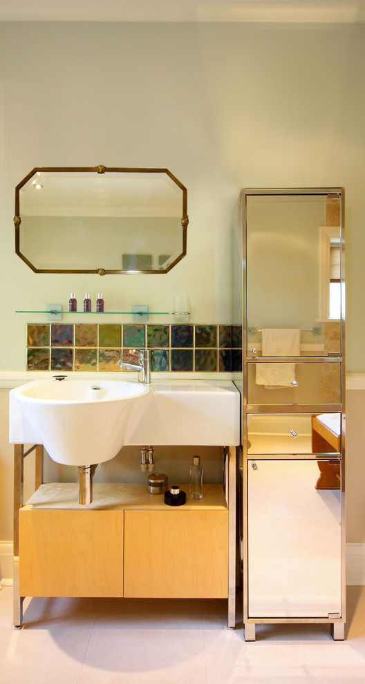 Inspiration for an eclectic half tiled bathroom in London with an integrated sink, multi-coloured tiles, flat-panel cabinets and light wood cabinets.