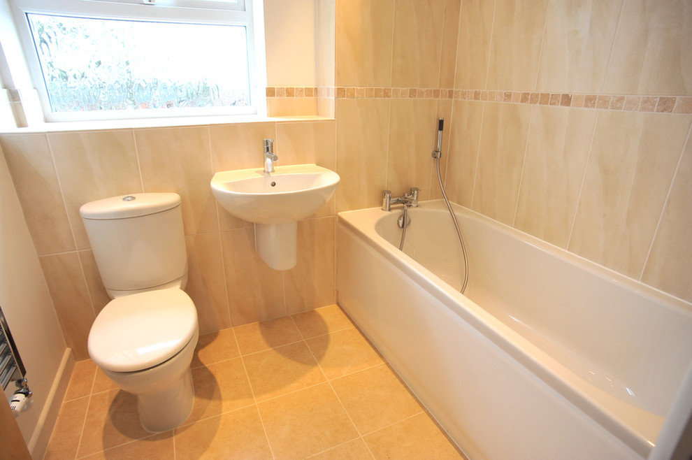 This is an example of a medium sized contemporary bathroom in Kent with a submerged sink, a submerged bath, a shower/bath combination, a two-piece toilet, brown tiles and brown walls.
