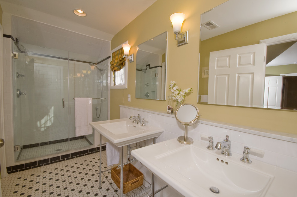This is an example of a traditional ensuite bathroom in Columbus with a console sink, an alcove shower, a two-piece toilet, white tiles and yellow walls.