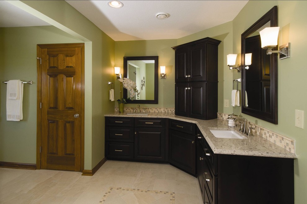 Eclectic master beige tile and ceramic tile limestone floor bathroom photo in Columbus with an undermount sink, raised-panel cabinets, black cabinets, granite countertops, a two-piece toilet and green walls