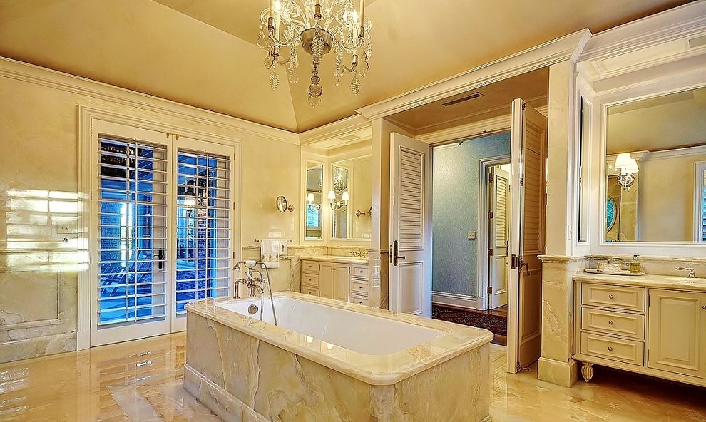 Traditional bathroom in Miami with beige cabinets and a freestanding bath.