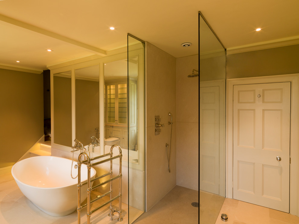 Large contemporary ensuite bathroom in Other with a built-in sink, raised-panel cabinets, green cabinets, marble worktops, a freestanding bath, a walk-in shower, a one-piece toilet, brown walls and limestone flooring.