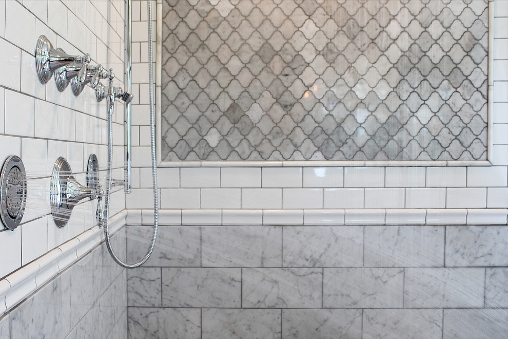 Large farmhouse ensuite bathroom in Minneapolis with shaker cabinets, grey cabinets, a freestanding bath, a corner shower, stone tiles, grey walls, light hardwood flooring, a built-in sink, marble worktops and grey tiles.