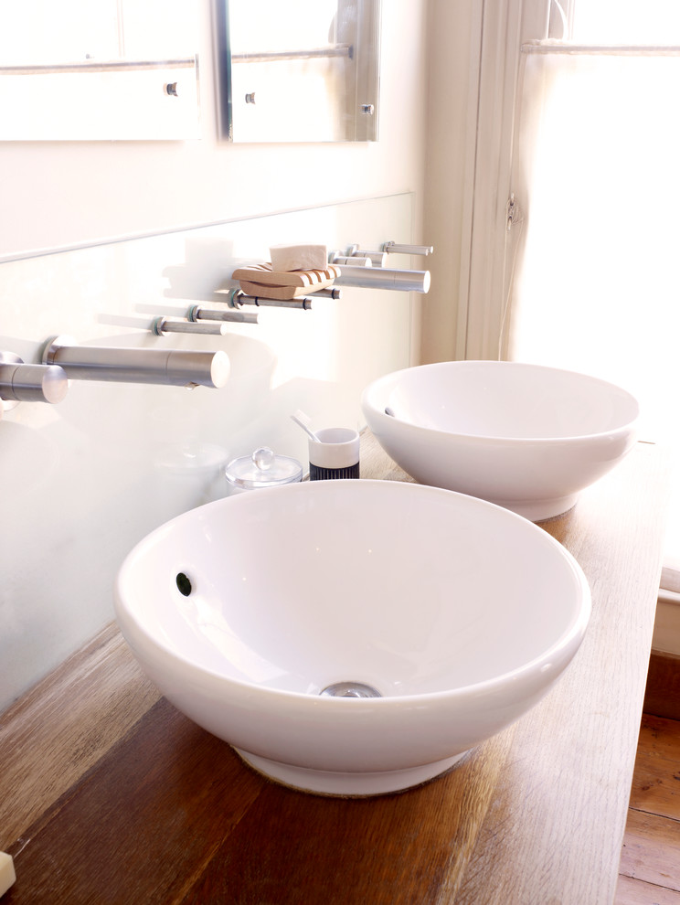 Inspiration for a medium sized contemporary ensuite bathroom in London with a vessel sink, flat-panel cabinets, medium wood cabinets, wooden worktops, beige walls and medium hardwood flooring.