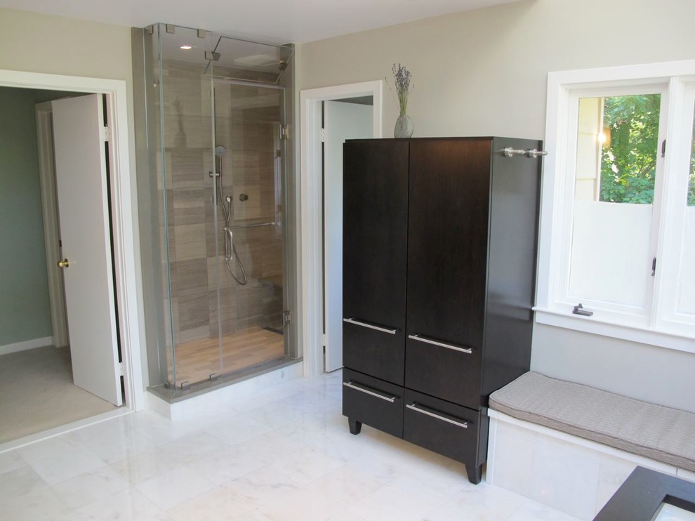 Inspiration for a large contemporary master brown tile and porcelain tile marble floor and white floor corner shower remodel in DC Metro with flat-panel cabinets, dark wood cabinets, beige walls and a hinged shower door