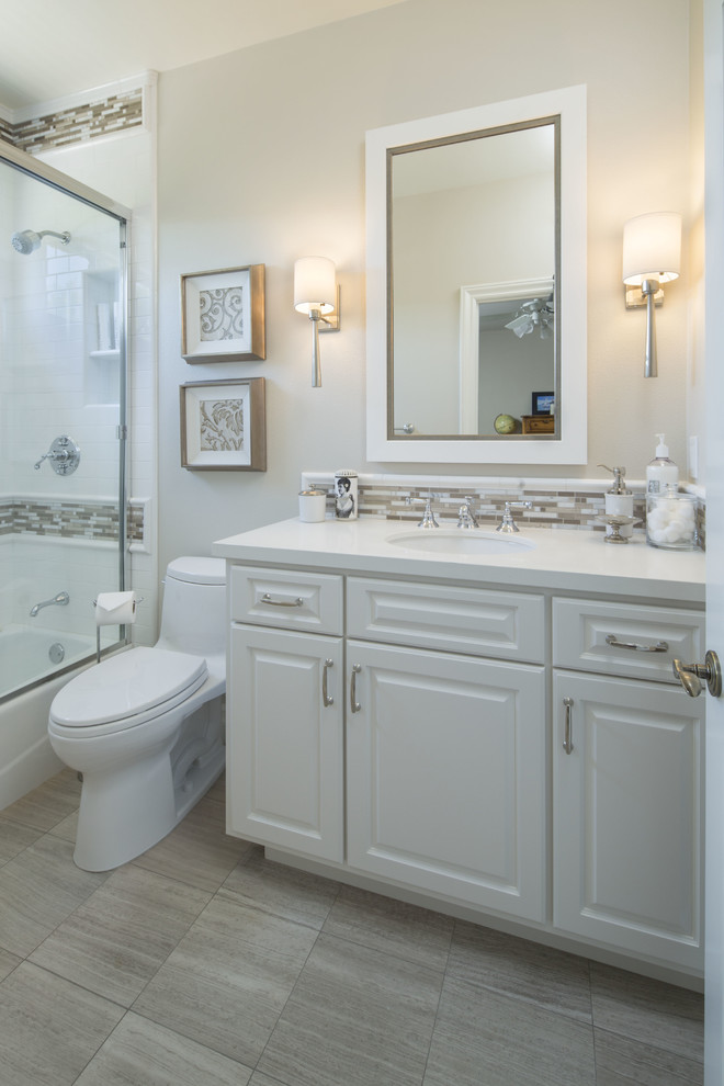Inspiration for a medium sized classic shower room bathroom in Orange County with an integrated sink, shaker cabinets, white cabinets, engineered stone worktops, a freestanding bath, a shower/bath combination, a one-piece toilet, white tiles, white walls, ceramic flooring, brown floors and white worktops.