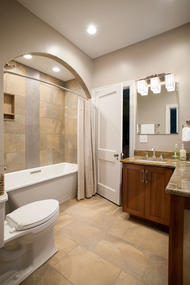 Mid-sized zen master beige tile and porcelain tile ceramic tile bathroom photo in St Louis with beaded inset cabinets, medium tone wood cabinets, a one-piece toilet, beige walls, an undermount sink and granite countertops