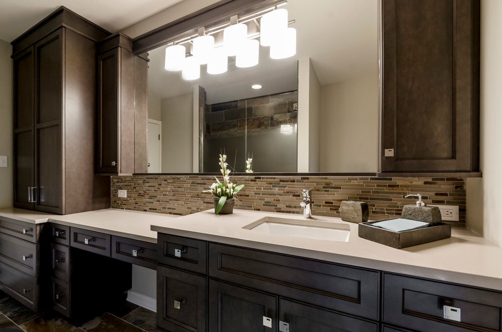 Photo of a large traditional ensuite bathroom in Chicago with recessed-panel cabinets, dark wood cabinets, an alcove shower, multi-coloured tiles, glass tiles, beige walls, a submerged sink and quartz worktops.