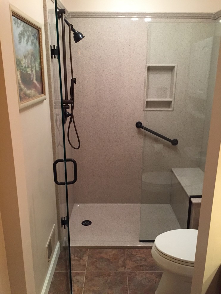 Small trendy 3/4 ceramic tile and brown floor alcove shower photo in Louisville with a two-piece toilet, beige walls and a hinged shower door