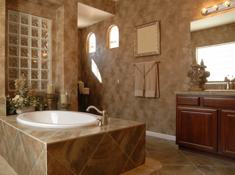 Design ideas for a large mediterranean ensuite bathroom in Louisville with raised-panel cabinets, dark wood cabinets, a built-in bath, a built-in shower, brown walls, ceramic flooring, a built-in sink, tiled worktops, brown floors and an open shower.