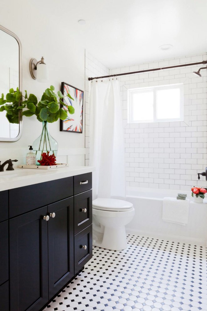 Traditional shower room bathroom in DC Metro with recessed-panel cabinets, black cabinets, an alcove bath, a shower/bath combination, white tiles, metro tiles, white walls, a submerged sink, multi-coloured floors, a shower curtain and white worktops.