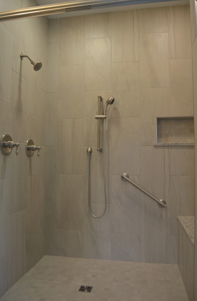 Photo of a large classic ensuite bathroom in Other with raised-panel cabinets, dark wood cabinets, an alcove bath, a walk-in shower, a two-piece toilet, grey tiles, porcelain tiles, grey walls, porcelain flooring, a submerged sink and granite worktops.