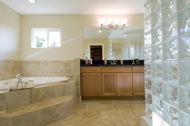 Ejemplo de cuarto de baño clásico con armarios estilo shaker, puertas de armario de madera clara, bañera encastrada y paredes blancas