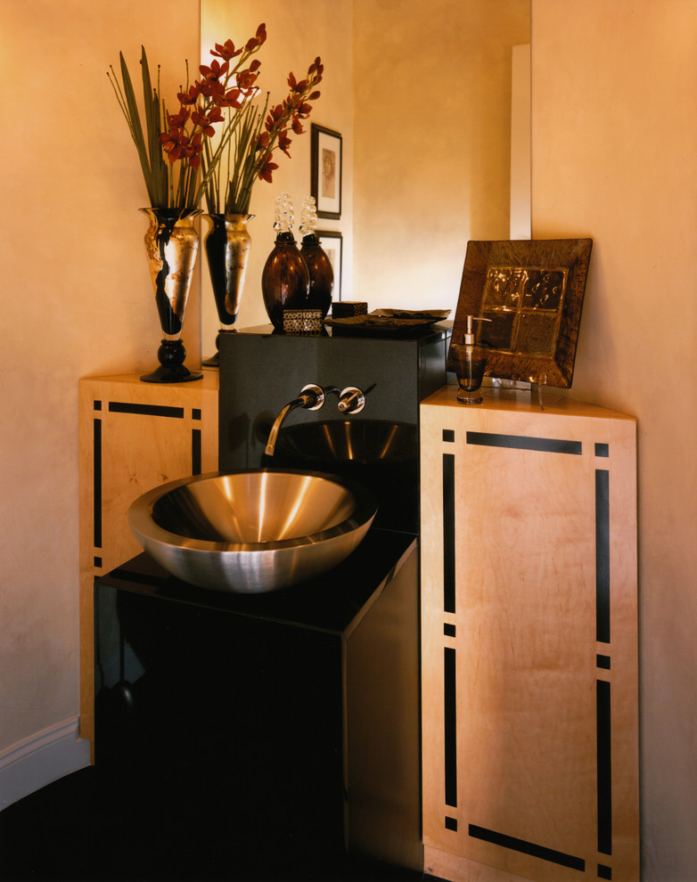 Photo of a medium sized contemporary bathroom in San Diego with black worktops, beige cabinets, beige walls, a vessel sink, granite worktops and black floors.