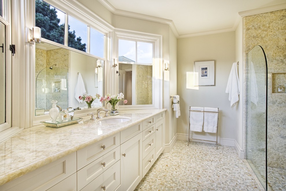 Example of a large classic beige tile limestone floor alcove shower design in San Francisco with an undermount sink, recessed-panel cabinets and white cabinets