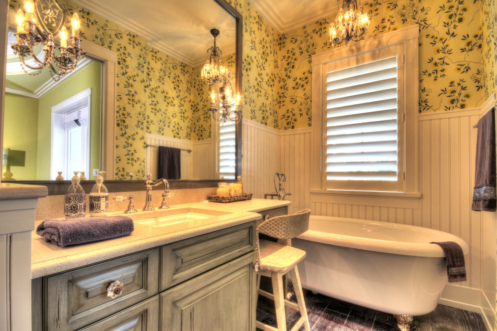 Inspiration för ett mellanstort lantligt en-suite badrum, med luckor med upphöjd panel, grå skåp, ett badkar med tassar, gula väggar, mörkt trägolv, ett undermonterad handfat, bänkskiva i terrazo och brunt golv