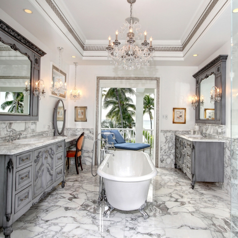Inspiration for a large timeless master white tile and marble tile marble floor and white floor freestanding bathtub remodel in Miami with gray cabinets, a two-piece toilet, white walls, a drop-in sink and marble countertops
